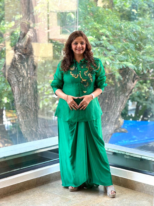 Emerald green organza collared shirt with applique work and silk pleated skirt ensemble